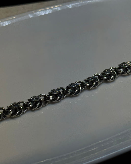 Metallic chain on a reflective surface