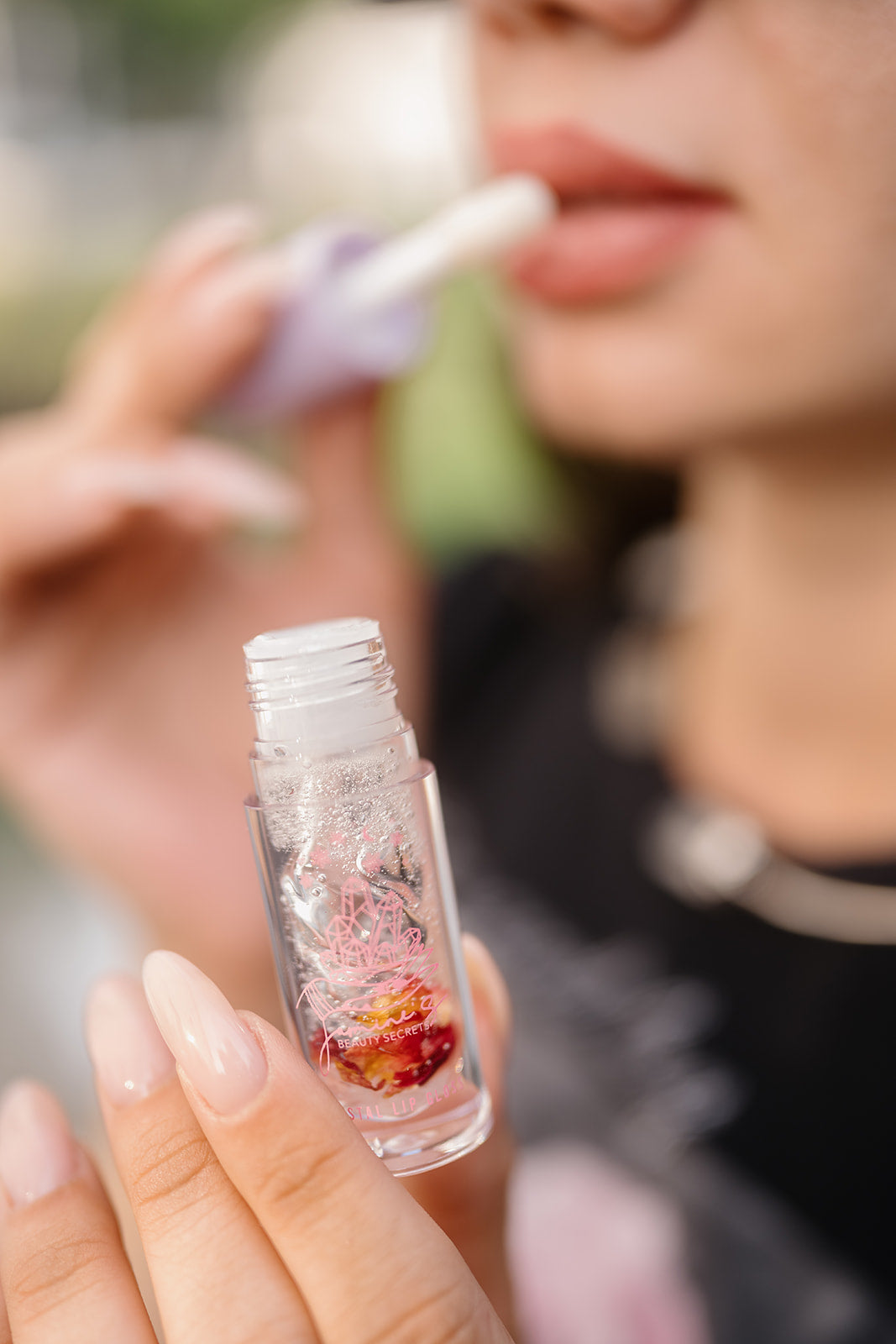 putting lip gloss on