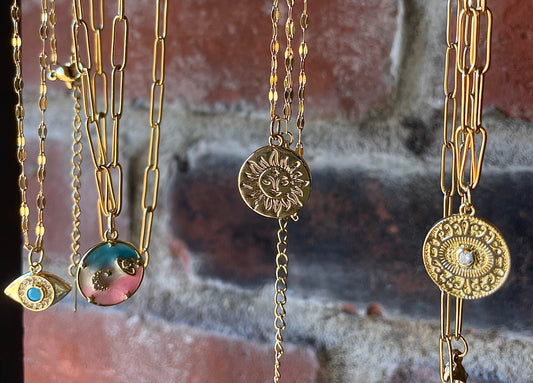 Assorted gold necklaces with charms