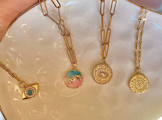 Assorted gold necklaces with charms